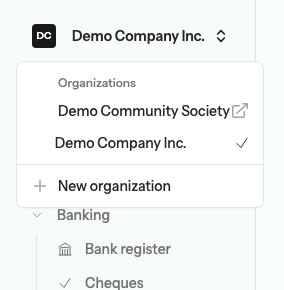 The organization switcher menu open at the top of the sidebar, listing Demo Company Inc. with a check mark, Demo Community Society with an open-in-new-tab arrow, and a New organization item
