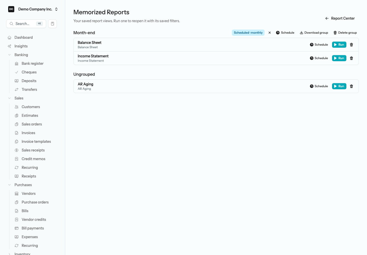 The Memorized Reports page showing a group heading with a Scheduled · monthly badge and Schedule, Download group, and Delete group buttons, rows with Run and Schedule buttons, and an Ungrouped section